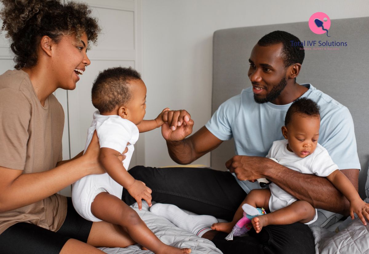 Smiling parents spending quality time with their twin babies while playing together at home.